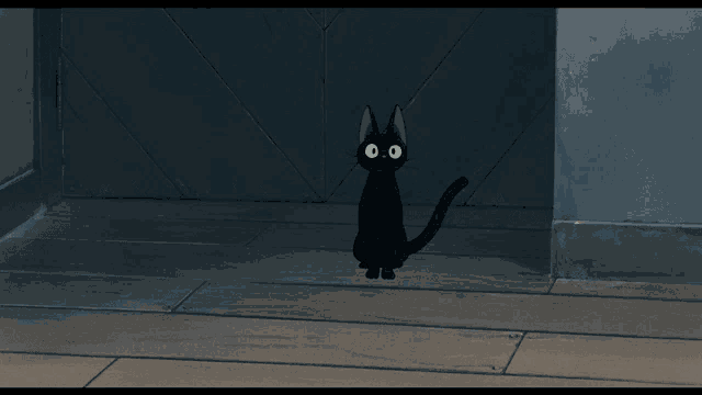 a black cat with yellow eyes is standing in a dark room