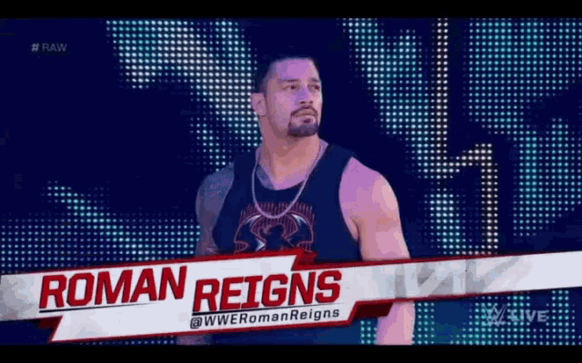 a wrestler named roman reigns is standing in front of a crowd on a stage .
