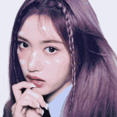 a woman with purple hair has a braid in her hair