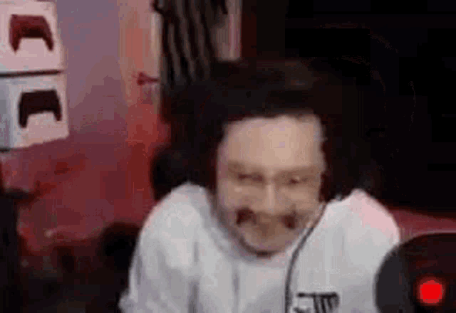 a man is sitting in front of a computer with a microphone on his head .