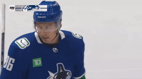a hockey player wearing a blue jersey with the number 96