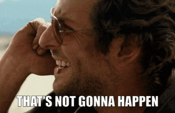 a man with glasses is laughing with the words that 's not gonna happen above him