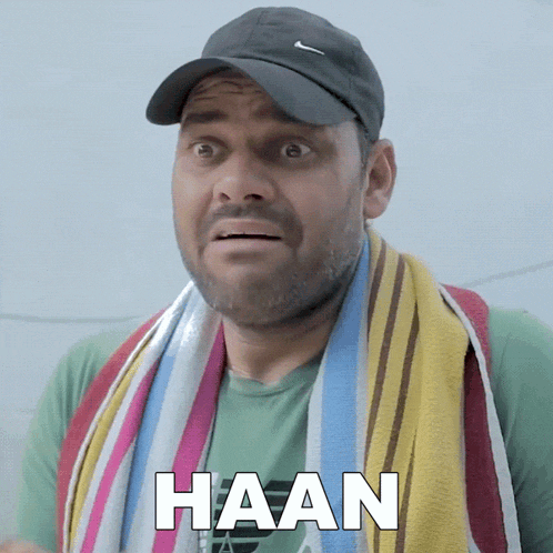 a man wearing a hat and a towel around his neck has the word haan written on his face
