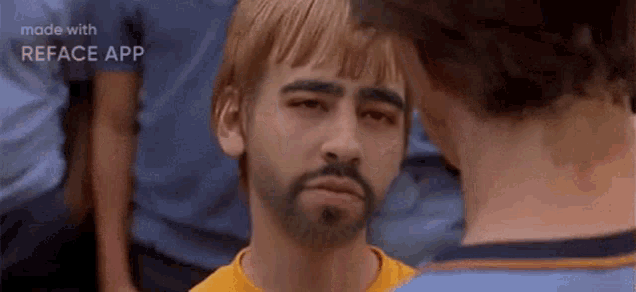 a man with a beard and blonde hair is looking at another man with a beard and blonde hair .