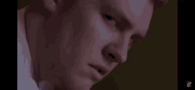 a close up of a man 's face with a serious expression .