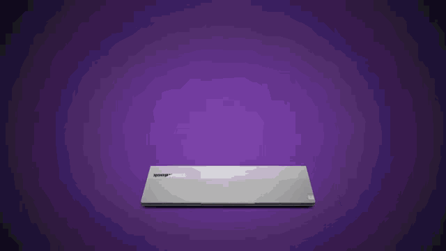 a laptop with a 16:10 aspect ratio screen is displayed on a purple background