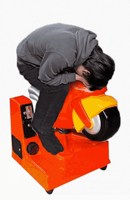 a man sits on an orange motorcycle with a coin slot on the side