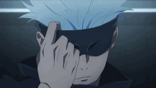 a close up of a person covering their eyes with their hands