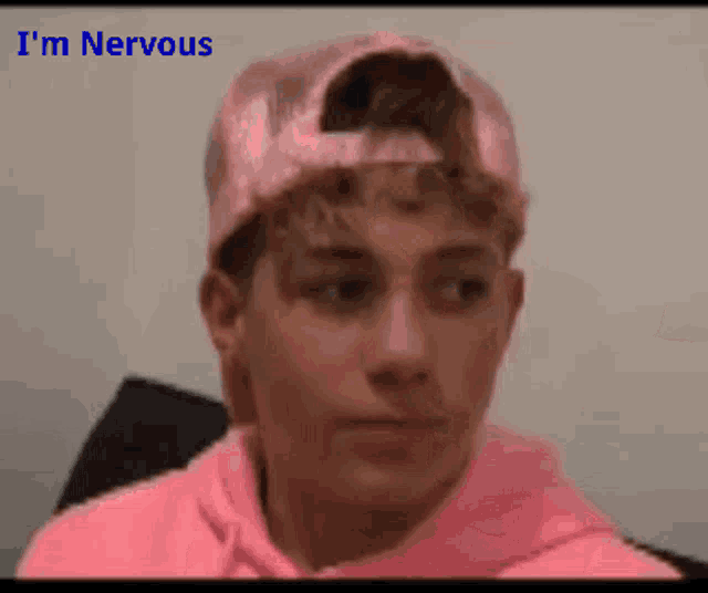 a young man wearing a pink hat and a pink hoodie says he is nervous