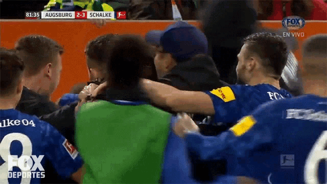 a group of soccer players are huddled together with the fox deportes logo on the bottom