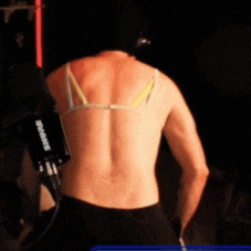 a man without a shirt is standing in front of a shure camera