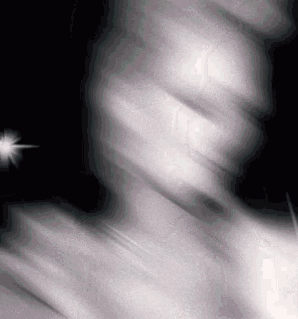 a blurred image of a person 's face with a light shining in the background