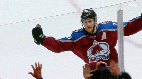 a hockey player wearing a jersey with the letter a on the front