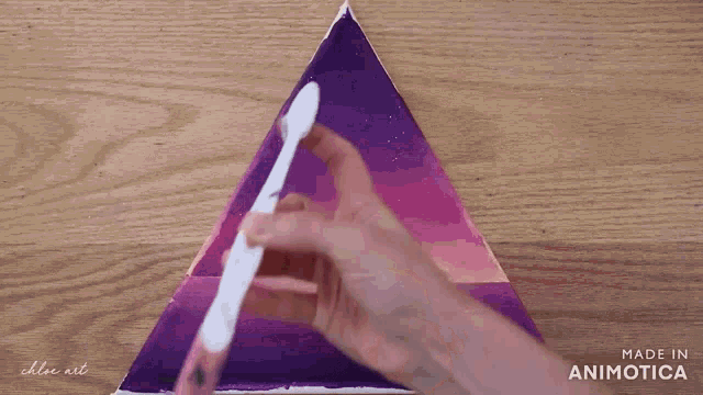 a purple and pink painting on a wooden table made in animatica