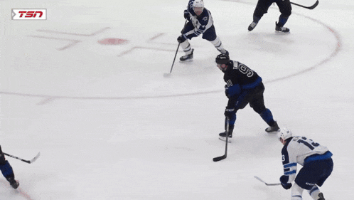 a hockey game is being played in front of a banner that says esso medals