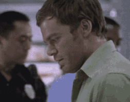 a man in a green shirt with a police badge on his chest