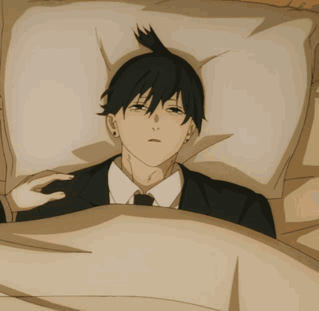 a man in a suit is laying in a bed