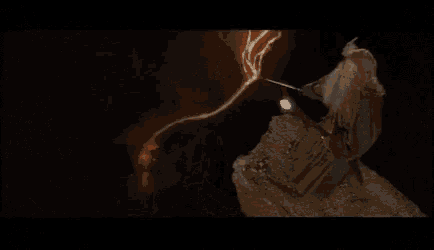 a close up of a person 's face with their hair blowing in the wind in a movie .