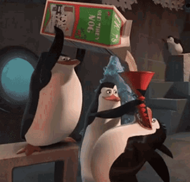 two penguins are standing next to each other and one of them is holding a carton of nog