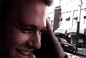 a close up of a man talking on a cell phone