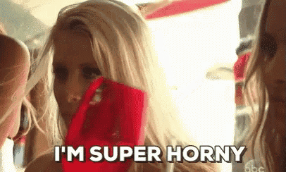 a blonde woman is holding a red scarf over her mouth and saying i 'm super horny .