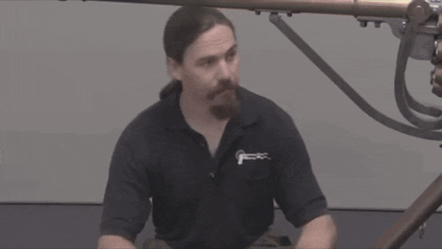 a man wearing a black shirt that says ' jc ' on it