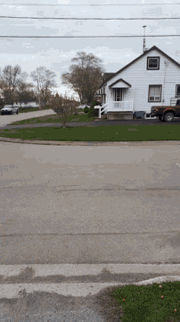 a white house with a red truck parked in front