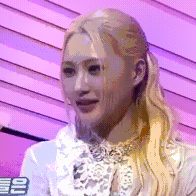 a close up of a woman with blonde hair wearing a white shirt and a bow tie .