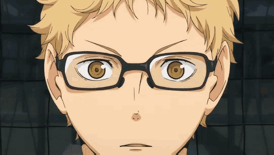 a close up of a person wearing glasses with a serious look on their face