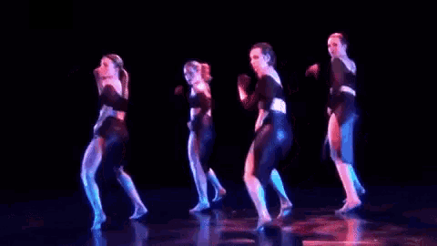 a group of people are dancing on a stage