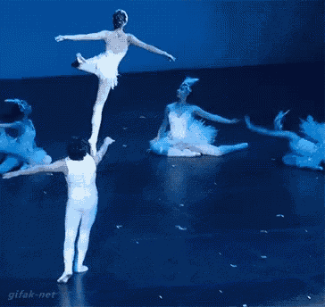 a group of ballet dancers performing on a stage with gitak-net written on the bottom right