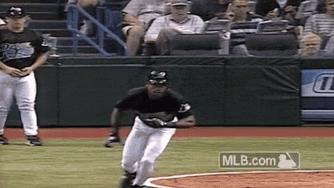 a baseball player is running on the field with a mlb.com logo behind him