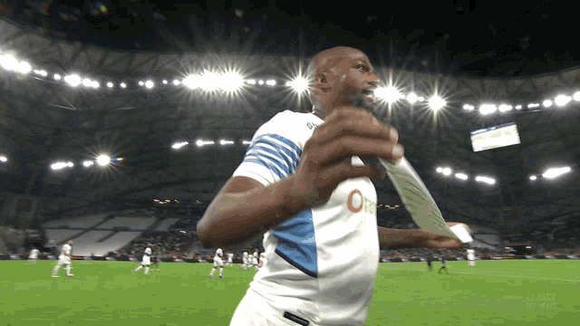 a soccer player in a white jersey with the letter o on the front