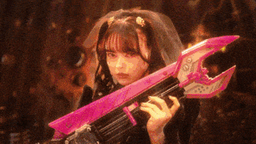 a woman in a veil is holding a pink weapon