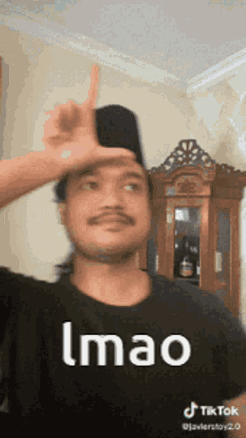a man is wearing a black shirt that says imao