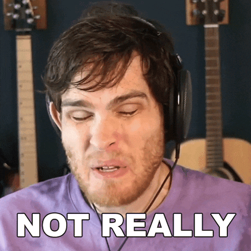 a man wearing headphones and a purple shirt says " not really "