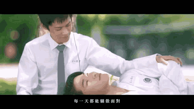 a man in a white shirt and tie is laying on another man 's lap