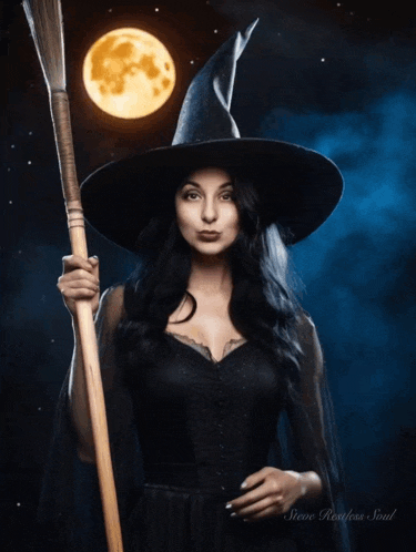 a woman in a witch costume is holding a broom