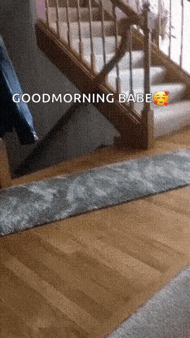 a person is standing in front of a staircase and says good morning babe