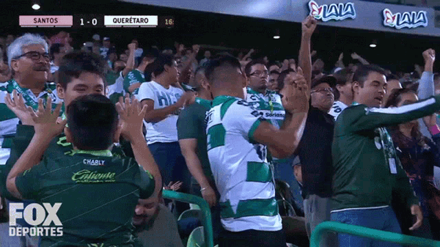 a crowd of people watching a soccer game with fox deportes written on the bottom of the screen