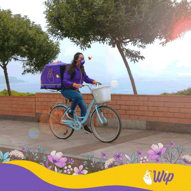 a woman wearing a face mask is riding a bike with a bag on the back