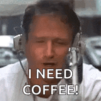 a man wearing headphones is talking into a microphone and says `` i need coffee ! ''