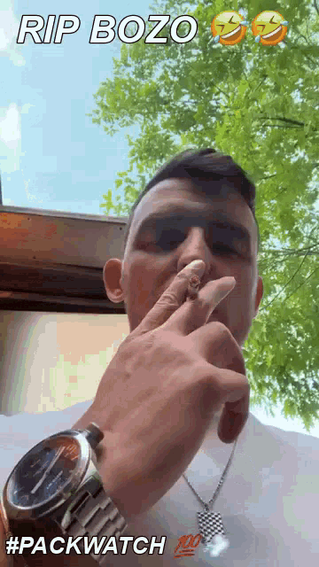 a man wearing a watch is smoking a cigarette with the caption rip bozo