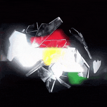 a black background with a few pieces of colored glass