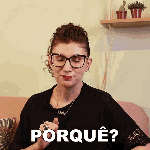 a woman wearing glasses and a black shirt is asking the question porque