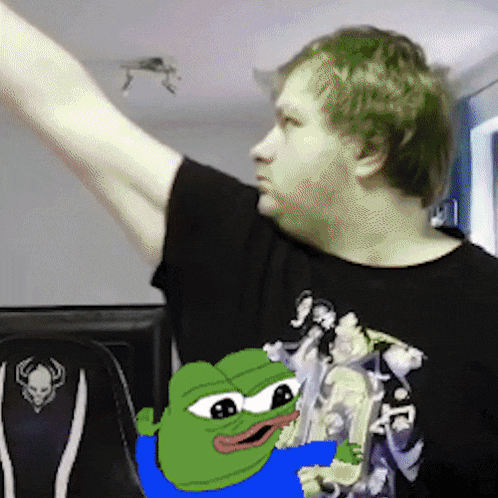 a man in a black shirt with a green frog on it