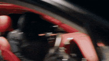 a blurry picture of a red car with a black background