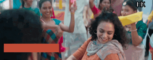 a group of people are dancing and smiling with hk written in the corner