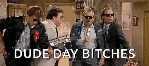 a group of men in suits and sunglasses are standing next to each other in a living room .