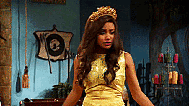 a woman wearing a yellow dress and a gold crown